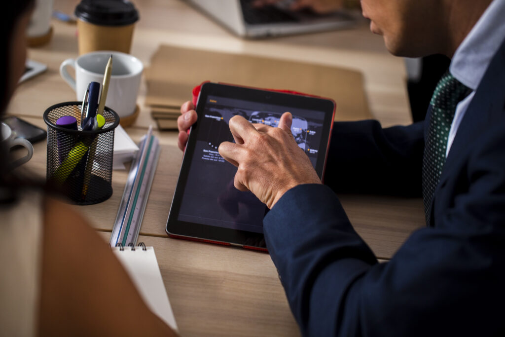 high angle employees using tablet