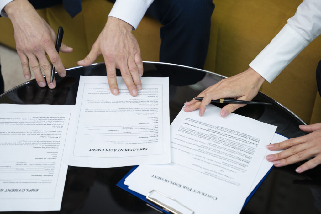 high angle hands signing documents