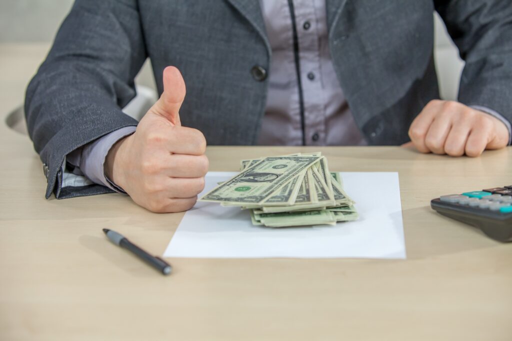 young businessman working from his office counting cash money